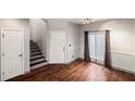 Entryway with hardwood floors, gray trim, stairs and neutral-toned walls at 8207 Fairview Blf, Alpharetta, GA 30022