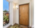 Condo entryway with a wooden front door, welcome mat, and natural light from a nearby window at 1133 Church St # 1, Covington, GA 30014