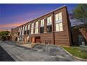 View of a brick building with large windows, commercial entrances, and designated parking spaces at 1133 Church St # 1, Covington, GA 30014