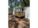 Home exterior featuring wood deck, gray siding, and surrounding trees at 5400 Kings Camp Rd, Acworth, GA 30102