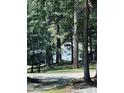 Home exterior surrounded by lush mature trees and wooded views at 5400 Kings Camp Rd, Acworth, GA 30102