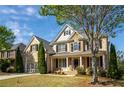 Charming brick home with mature trees, a two-car garage, and a welcoming front porch at 5650 Upper Creek Ct, Suwanee, GA 30024