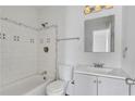 Bright bathroom with a shower-tub combo, white tile, and a vanity with sink at 934 Joseph E Boone Nw Blvd, Atlanta, GA 30314