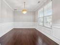 Elegant dining room features wainscoting, hardwood floors, and a chandelier at 368 Sawyer Meadow Way, Grayson, GA 30017