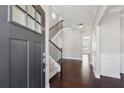 Grand foyer with hardwood floors, staircase, and a view into the living area at 368 Sawyer Meadow Way, Grayson, GA 30017