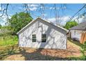 Exterior showcasing the backyard of a light-colored home featuring tidy lawn and new siding at 944 Joseph E Boone Nw Blvd, Atlanta, GA 30314