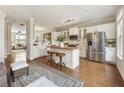 Bright kitchen featuring white cabinets, a butcher block island, and stainless steel appliances at 11265 Musette Cir, Alpharetta, GA 30009