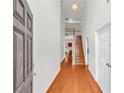 Inviting foyer featuring hardwood floors, a staircase, and high ceilings creates a grand entrance to the home at 1211 Liverpool Pointe, Lawrenceville, GA 30046