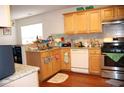Cozy kitchen with granite countertops, stainless steel appliances, and wooden cabinetry at 1211 Liverpool Pointe, Lawrenceville, GA 30046