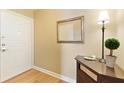 Cozy entryway with a mirror, dark wood console table, lamp, and lush plant, creating a welcoming ambiance at 1101 Juniper Ne St # 632, Atlanta, GA 30309