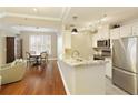 Bright kitchen with white cabinets, stainless steel appliances, granite countertops, and wood flooring at 1101 Juniper Ne St # 632, Atlanta, GA 30309