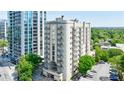 Exterior shot of condo building featuring multiple balconies and lush greenery surrounding the property at 2161 Peachtree Ne Rd # 907, Atlanta, GA 30309