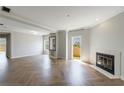 Living room featuring herringbone floors, fireplace, and access to a private balcony at 2161 Peachtree Ne Rd # 907, Atlanta, GA 30309