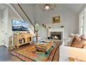 Cozy living room with a fireplace, hardwood floors, and ample natural light at 5485 Woodrun Ln, Johns Creek, GA 30005