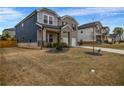 A charming two-story home with a mix of siding and brick, complemented by a well-kept lawn at 787 Milo Bay Street, Loganville, GA 30052