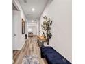 Inviting hallway with wood floors, leading to a naturally lit living space at 787 Milo Bay Street, Loganville, GA 30052