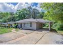 Inviting home with a covered parking area and a pathway leading to the front door at 1973 Columbia Dr, Decatur, GA 30032