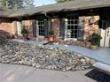 Charming red brick home with dark shutters and tasteful landscaping with decorative stones and potted plants at 2112 Fisher Ne Trl, Atlanta, GA 30345