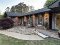 Beautiful red brick home featuring a well-maintained lawn and decorative rock landscaping at 2112 Fisher Ne Trl, Atlanta, GA 30345