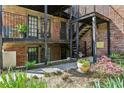 Charming brick building with iron balconies and lush landscaping creating an inviting outdoor space at 3091 Colonial Way # F2, Atlanta, GA 30341