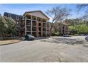A multi-story condominium complex showcases classic architectural design and ample parking at 3091 Colonial Way # F2, Atlanta, GA 30341