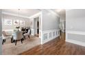 Elegant dining room featuring hardwood floors, wainscoting, and a modern chandelier at 225 Mary Jane Ln, Covington, GA 30016