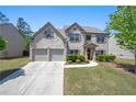 Charming two-story brick home with well-manicured lawn and attached two-car garage at 225 Mary Jane Ln, Covington, GA 30016