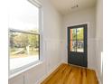 Bright entryway featuring hardwood floors, fresh paint, and a modern front door at 2286 Carver Nw Dr, Atlanta, GA 30314