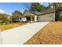 This is a nice view of the exterior of this house with a long concrete driveway at 2286 Carver Nw Dr, Atlanta, GA 30314