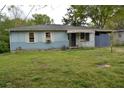 Charming light blue home with white shutters and covered porch, set on a grassy lot at 6232 Hospital Way, Douglasville, GA 30134
