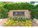 Stone sign for the Polo Golf & Country Club, surrounded by lush landscaping at 7405 Richmond Way, Cumming, GA 30040