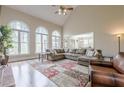 Bright living room with high ceilings, hardwood floors, and large windows at 7405 Richmond Way, Cumming, GA 30040