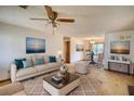 Bright living room featuring neutral walls, a ceiling fan, and an open dining area perfect for entertaining at 2140 Teri Ln, Conyers, GA 30013