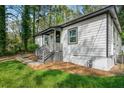 Home exterior with trimmed shrubs, walkway and updated siding at 437 Collier Ridge Nw Dr, Atlanta, GA 30318