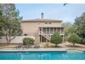 A relaxing backyard features a private pool, screened porch, and a well-maintained patio area at 7415 Northampton Ct, Cumming, GA 30040