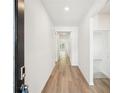 Bright hallway with hardwood floors leading to a carpeted room and a view of the living area, creating an open feel at 3953 Brushy St, Powder Springs, GA 30127