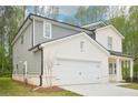 A lovely two-story home with a two-car garage and well-manicured lawn at 3961 Brushy St, Powder Springs, GA 30127
