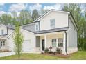 Beautiful two-story home with a covered porch and gray and white color scheme at 3961 Brushy St, Powder Springs, GA 30127