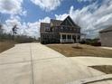 Spacious two-story home featuring a long driveway and a classic brick facade at 5458 Summer Pine Pl, Buford, GA 30518