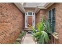Inviting brick entryway with a charming front door, decorative plants, and natural light at , Stone Mountain, GA 30088