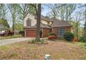 Charming brick and siding home with mature trees, two-car garage and manicured landscaping in a suburban setting at , Stone Mountain, GA 30088