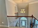 View from upstairs landing showcasing the chandelier and an arched entryway at 2557 Staunton Dr, Duluth, GA 30097
