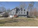 Beautiful home with a two-car garage, inviting front yard, and mature trees at 525 Penny Ln, Woodstock, GA 30188