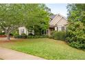 Inviting single-story home with lush front lawn and beautifully landscaped yard at 5628 Harbormist Dr, Powder Springs, GA 30127