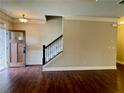 Inviting foyer features hardwood floors, staircase, and craftsman-style door at 725 Valley Glen Dr, Dacula, GA 30019
