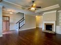 Open-concept living area features a fireplace, hardwood floors, and natural light at 725 Valley Glen Dr, Dacula, GA 30019