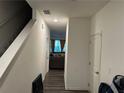 Welcoming hallway leading into a cozy living space with wood flooring at 136 Swindon Dr, Mcdonough, GA 30253