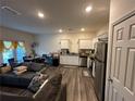 Open-concept living space features a kitchen with stainless steel appliances at 136 Swindon Dr, Mcdonough, GA 30253