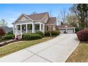Lovely home with a long driveway, well-maintained lawn, and a detached garage at 3902 Butterstream Nw Way, Kennesaw, GA 30144