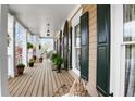 Inviting front porch with hanging plants, a vintage bench, and dark shutters at 3902 Butterstream Nw Way, Kennesaw, GA 30144
